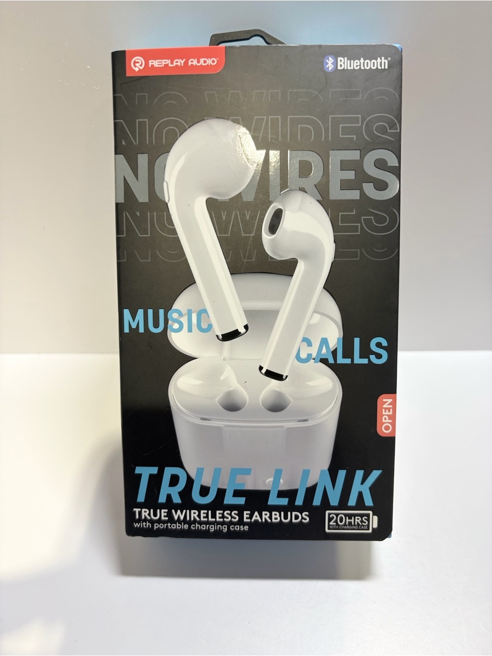 Replay Audio True Link wireless earbuds in white with a portable charging case.